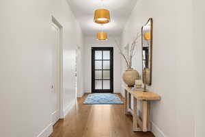 Entryway with wood finished floors and baseboards