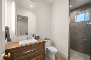 Full bath with vanity, a shower stall, light tile patterned flooring, and recessed lighting