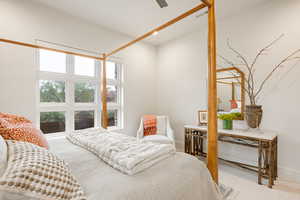 Carpeted bedroom featuring ceiling fan and baseboards