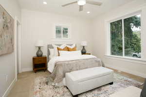 Carpeted bedroom with recessed lighting and ceiling fan