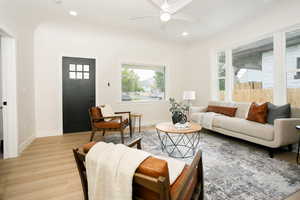 Living room featuring light wood finished floors, recessed lighting, and a ceiling fan
