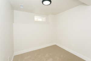 Basement featuring carpet floors and a textured ceiling