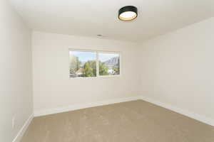 Spare room with carpet floors and a textured ceiling