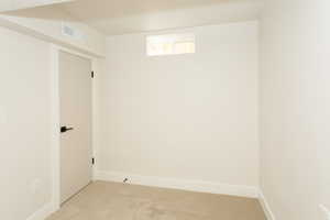 Basement featuring carpet and baseboards