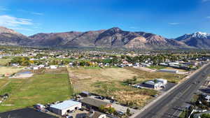 Aerial view of property's location featuring a mountainous background
