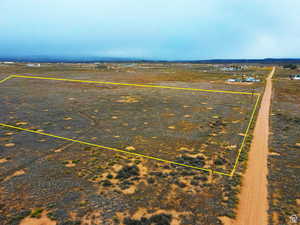 Aerial view of sparsely populated area with property parcel outlined