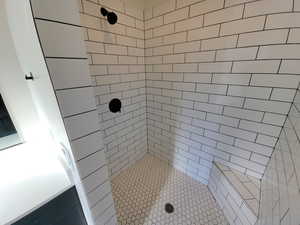 Full bath featuring a tile shower
