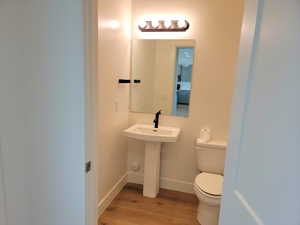 Bathroom featuring light wood finished floors and baseboards