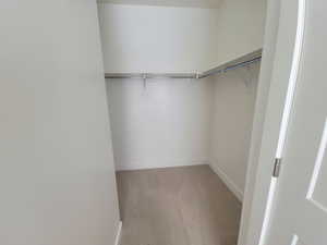 Walk in closet featuring light wood finished floors