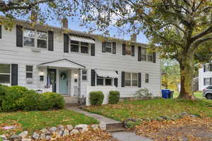 HOA managed front yard with succulents and mature trees.