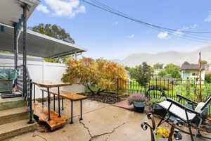 Temporarily Fenced backyard featuring a patio, 2 garden boxes, a shed, and a mountain view