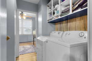 Laundry area with original hardwood flooring, ceiling fan, and washer and dryer (included) Cabinet doors are on the property - just not yet installed.