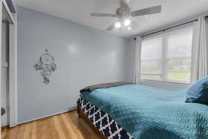 Bedroom with original hardwood flooring and a ceiling fan, and a mountain view