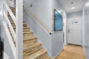 Entryway with blue pine stairs and original restored hardwood floors.