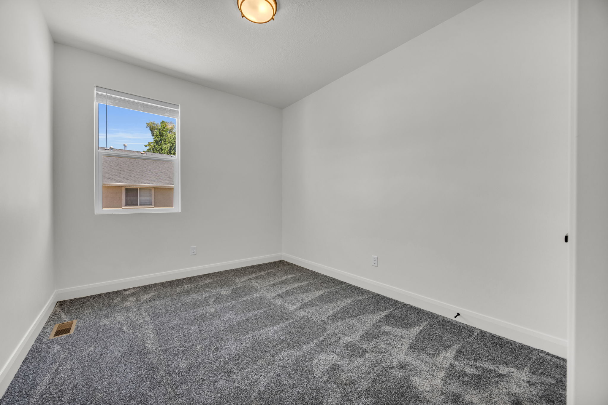 Unfurnished room featuring dark carpet and baseboards