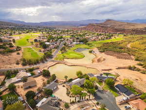 Aerial view of residential area with a local golf course and mountains