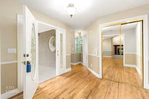 Doorway to outside with wood finished floors and a fireplace