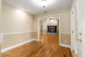 Interior space featuring light wood-style floors, a fireplace, and ceiling fan