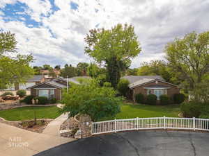 Ranch-style house featuring stucco siding