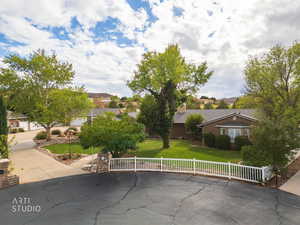 View of front facade with a fenced front yard and a gate