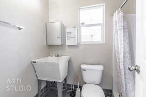 Bathroom with a shower with curtain and pet washing area