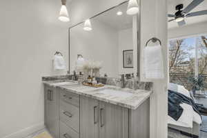 Ensuite bathroom with double vanity and ceiling fan