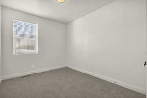 Carpeted empty room with baseboards
