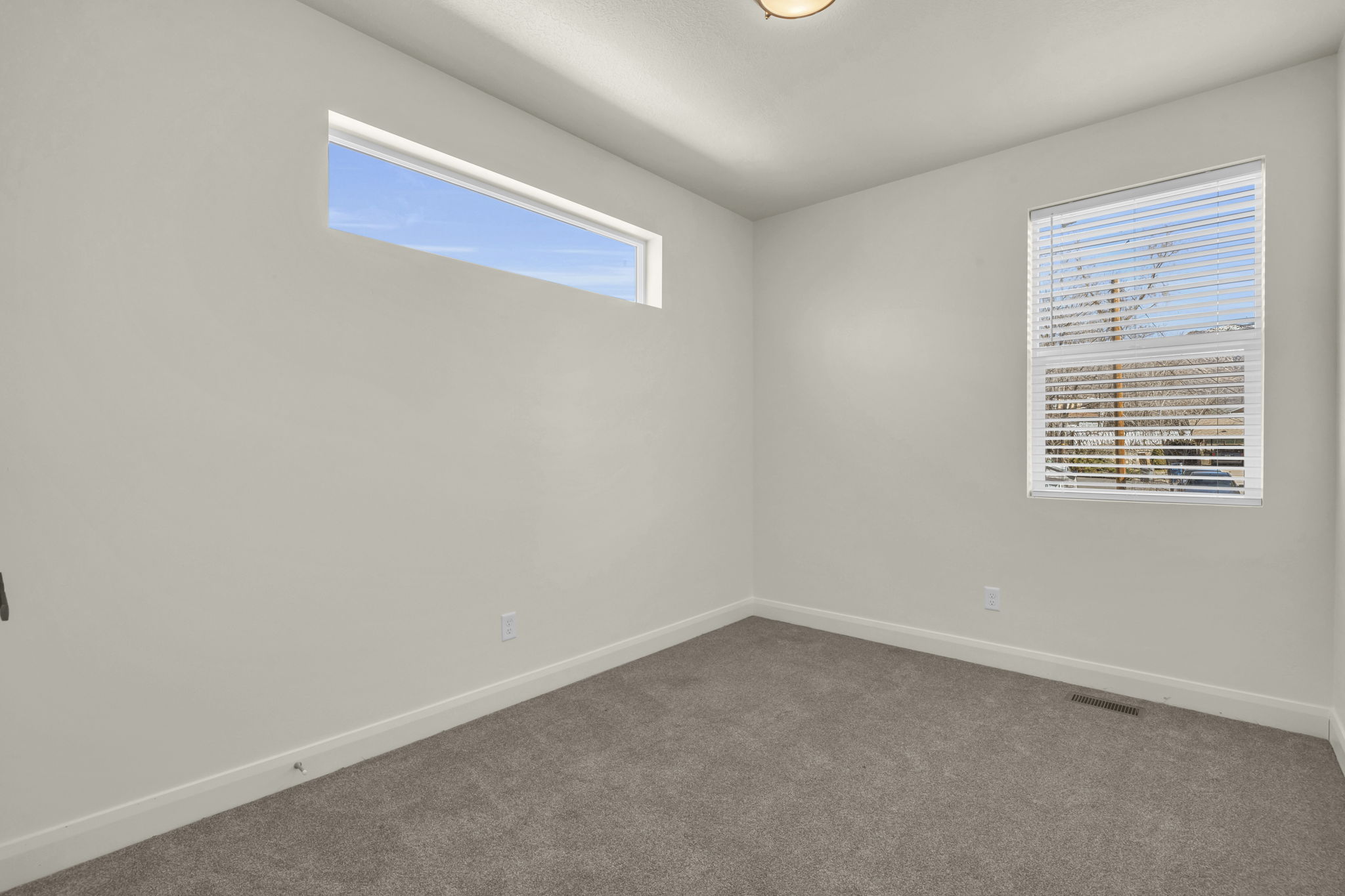 Empty room featuring baseboards and carpet flooring