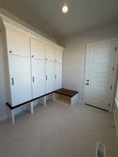 Mudroom with light tile patterned flooring and recessed lighting