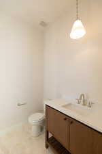 Bathroom with vanity and light flooring