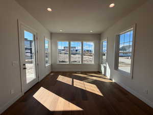 Unfurnished sunroom featuring recessed lighting, wood finished floors, and a textured ceiling