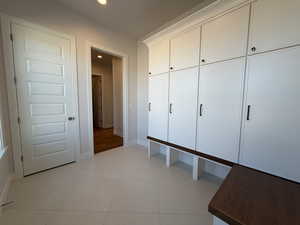 Mudroom with light tile patterned floors and recessed lighting