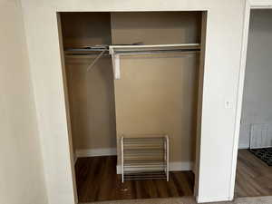 Bedroom closet with sliding doors and built-in hanging space.