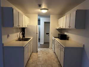 Kitchen featuring ample cabinet storage, counter space, and updated kitchen faucet.