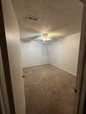 Comfortable primary bedroom with fresh paint, ceiling fan, closet space, and neutral carpet.