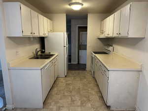 Ample cabinet storage and counter space with open layout to dining area.