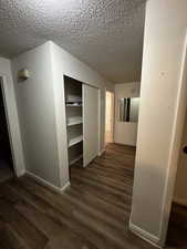 Hallway featuring built in storage and easy access to bedrooms and bathroom.