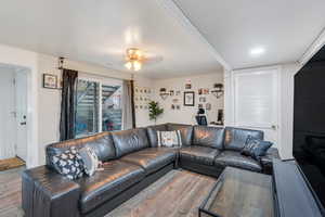 Living room with wood finished floors and ceiling fan