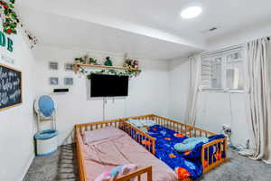 Carpeted bedroom with baseboards