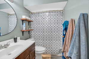Bathroom featuring vanity, a shower with curtain, and light tile patterned flooring