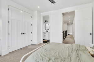 Bedroom featuring light carpet, recessed lighting, ensuite bathroom, and a closet