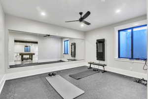 Workout area with a ceiling fan and recessed lighting