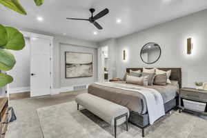 Bedroom featuring light colored carpet, recessed lighting, a ceiling fan, and connected bathroom