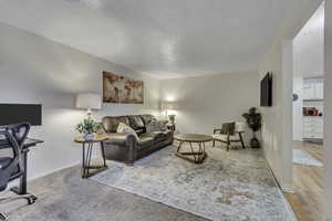 Living room featuring a desk and baseboards