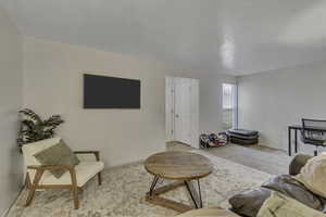 Living room with carpet floors and baseboards