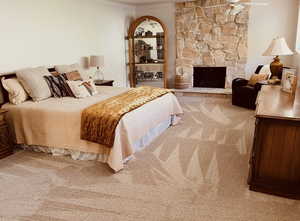 Bedroom with new carpet, a fireplace, and ornamental molding