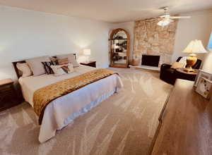 Bedroom with New carpeting, LOTS of extra space for sitting area by the custom stone fireplace, and ceiling fan too!