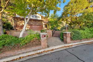 View of front facade with brick siding and driveway