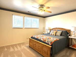 Onw of 4 upstairs bedrooms with new carpet, crown molding  and  ceiling fan.