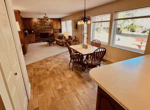 Dining room with "wood tiled "floors, with an occasional deer in the view.